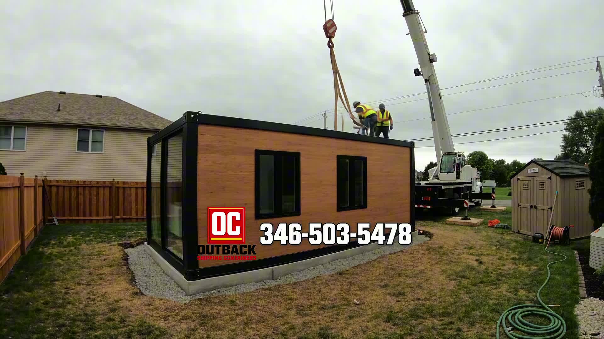 1-bedroom duplex container home with rooftop deck being set up in a backyard