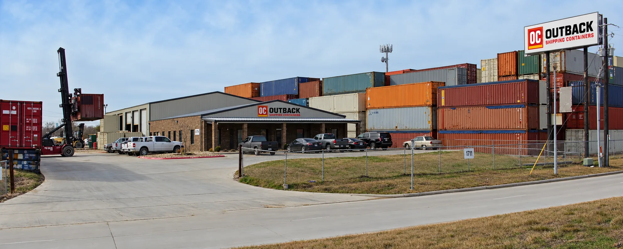 Outback Shipping Containers headquarters and storage yard at 10000 Wallisville Rd, Houston, TX — branded office building, stacked container inventory, and forklift loading a container